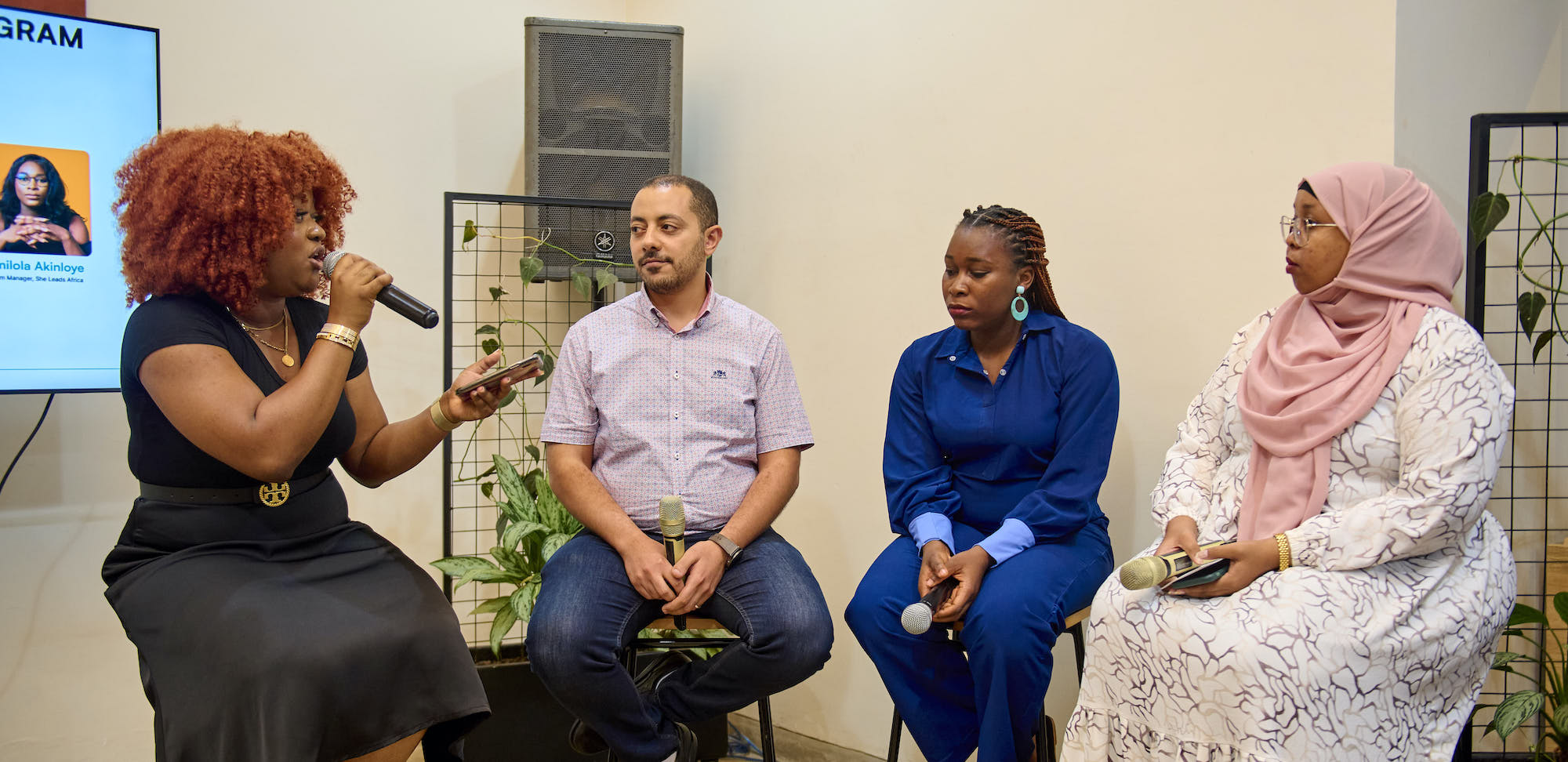 Picture of three women and one man seated for a panel discussion